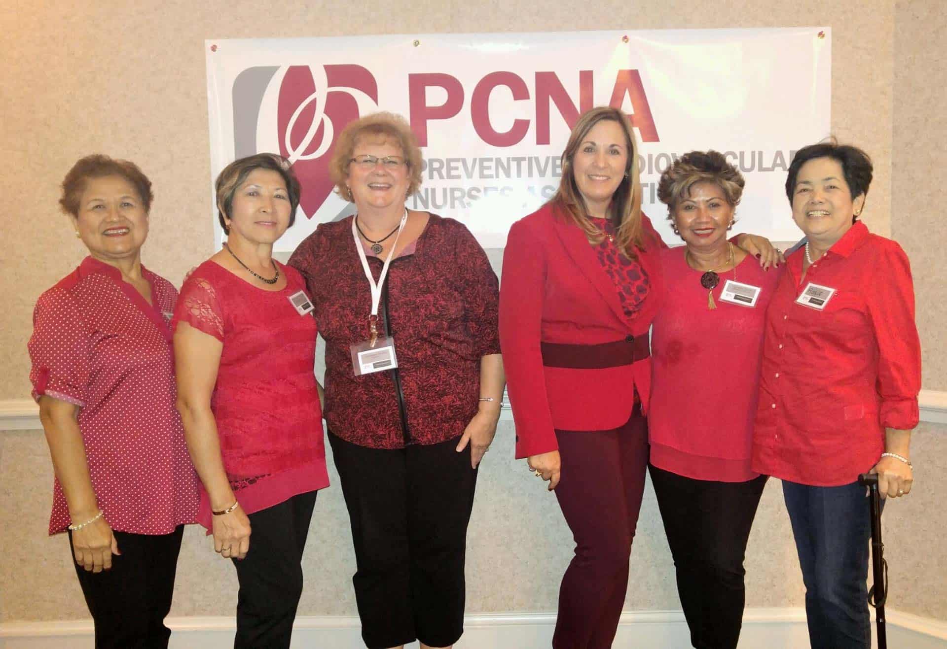 Chapter members posing in front of a banner