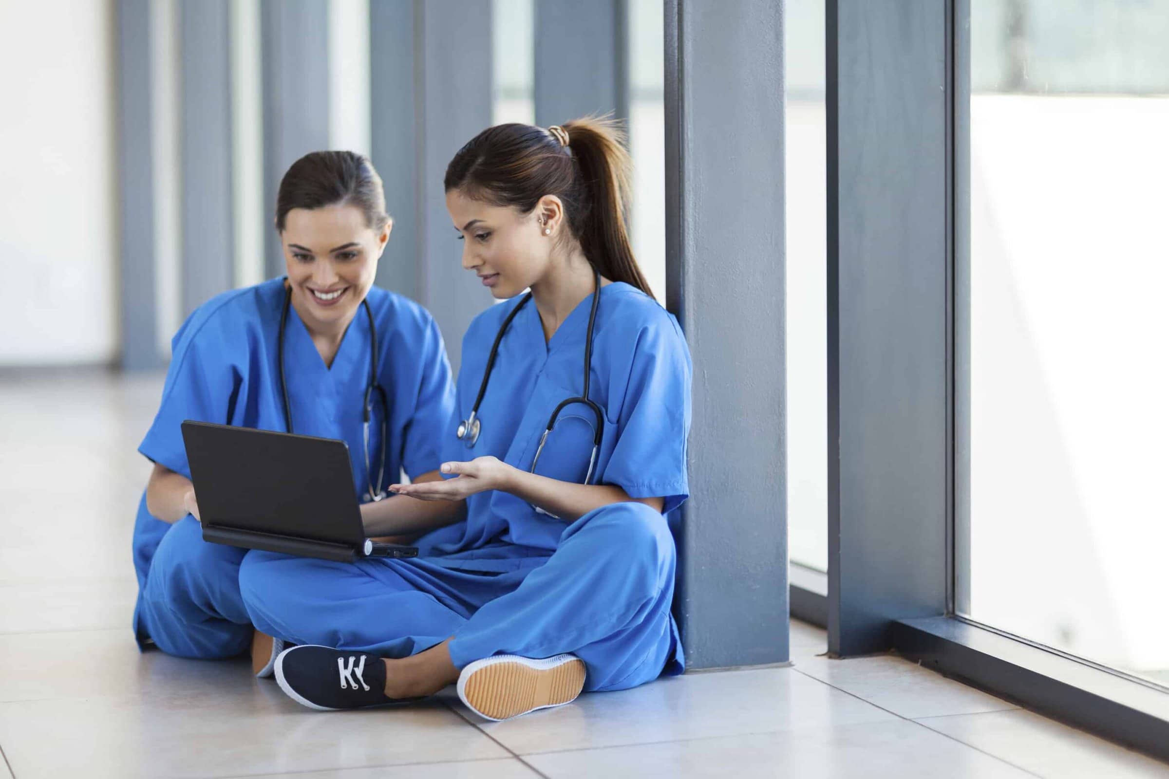 two nurses using laptop computer during break