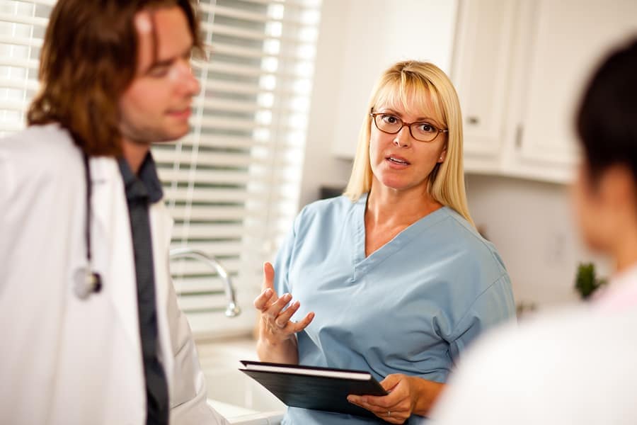 Doctors And Nurses Having Conversation
