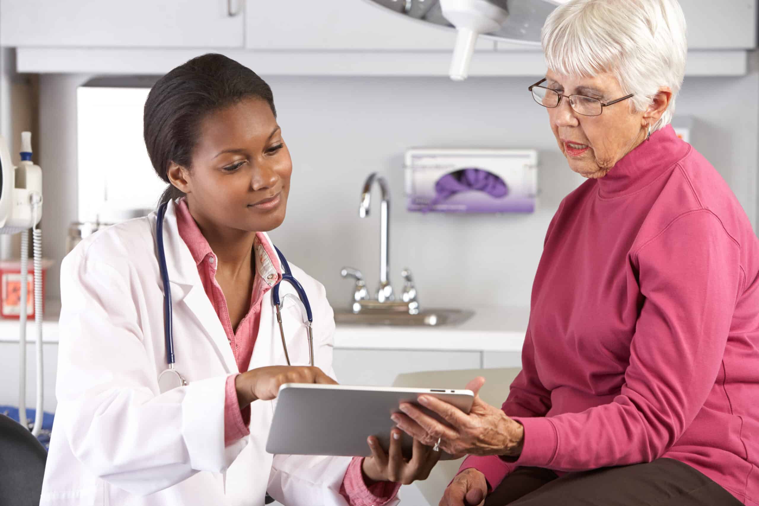 Doctor Discussing Records With Senior Female Patient Female Doctor Discussing Records With Senior Female Patient