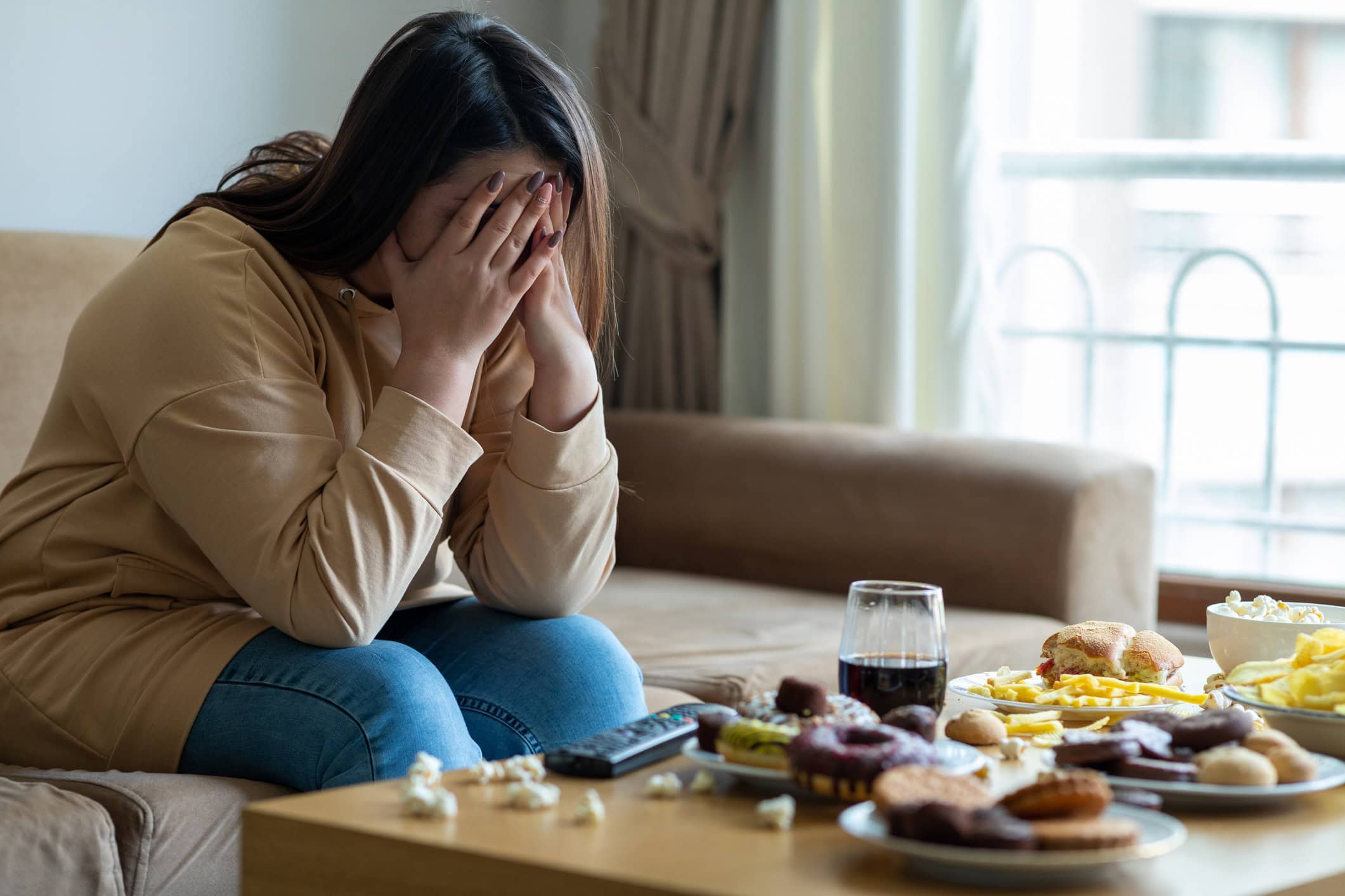 Unhappy stressed woman overeating