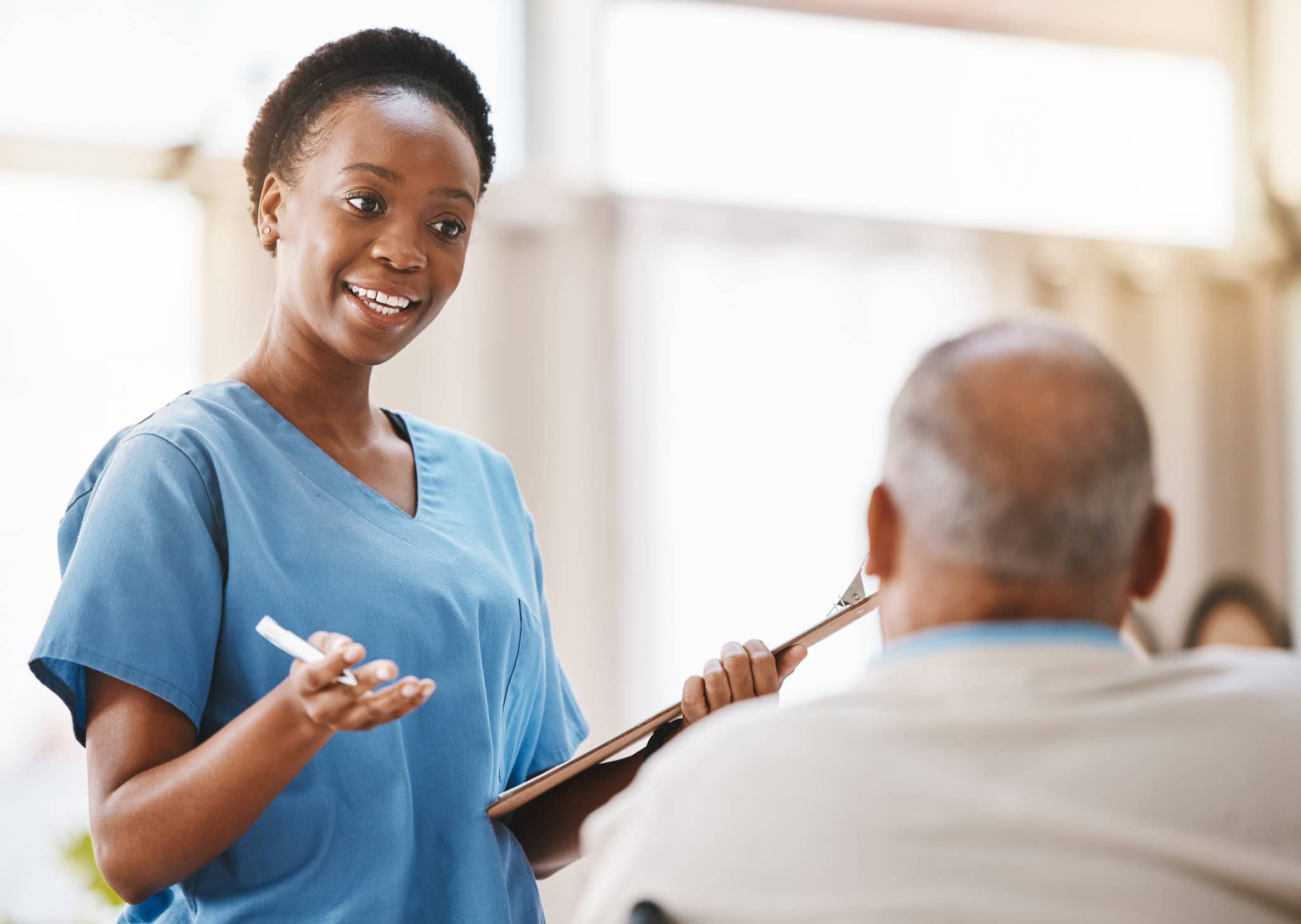 Consulting, medical and checklist with old man and nurse for retirement, rehabilitation or physical therapy. Help, empathy and healing with patient and black woman in nursing home for healthcare exam