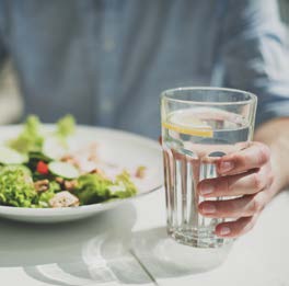 Glass of water with salad